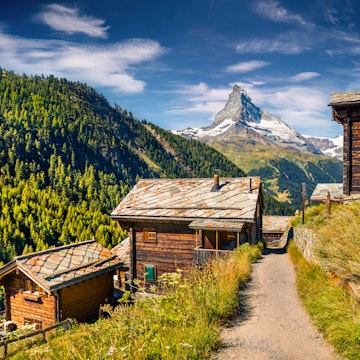 Sunny summer morning in Zermatt village with Matterhorn (Monte Cervino, Mont Cervin) peak on backgroud. Beautiful outdoor scene in Swiss Alps, Valais canton, Switzerland, Europe.